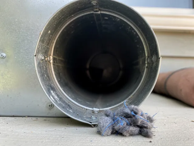 Manhattan Beach Dryer Vent Cleaning technician using specialized equipment to clear severe dryer vent blockage in Manhattan Beach